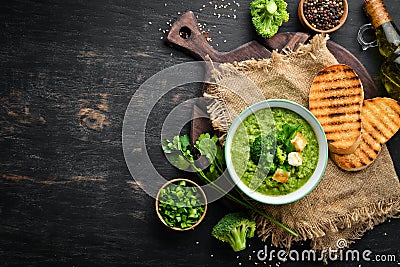 Broccoli, spinach cream soup in a bowl with toasted bread. Green soup. Dietary food. Stock Photo