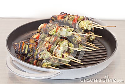 Broiled shish kabob on a stick in a skillet Stock Photo