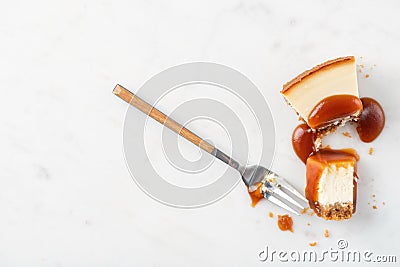 Broked slice of cheesecake with caramel sauce Stock Photo