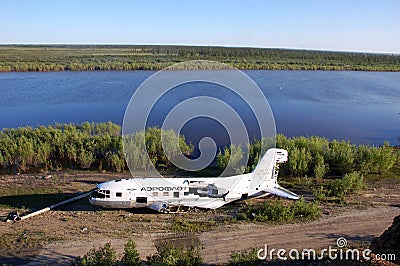 Broken abandoned airplane at Kolyma river coast Editorial Stock Photo