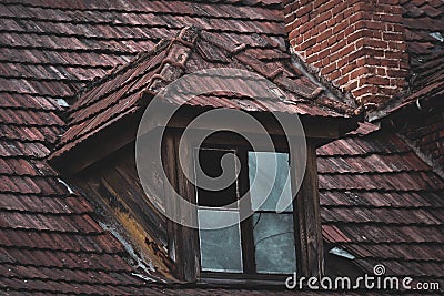 Broken attic window in an old building Stock Photo