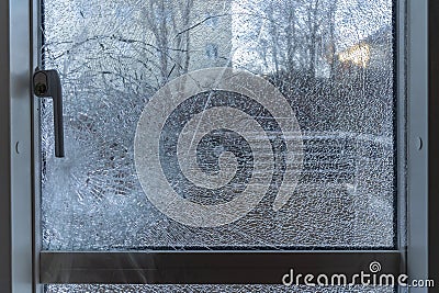 Broken balcony glass door window with shattered glass Stock Photo