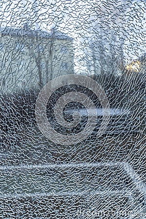 Broken balcony glass door window with shattered glass Stock Photo