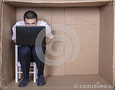 Broken businessman in a cardboard office, stress and depression from overwork Stock Photo