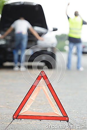 broken car concept breakdown triangle on road Stock Photo