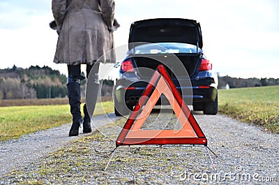 Broken car, girl and triangle Stock Photo