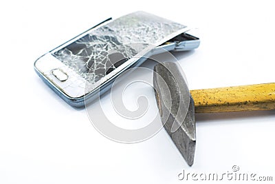 Broken cell phone with a hammer on a white background Stock Photo