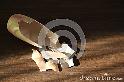 Broken ceramic vase on wooden floor, above view. Space for text Stock Photo