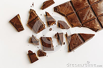 Broken chocolate bar, diagonal composition, white background Stock Photo