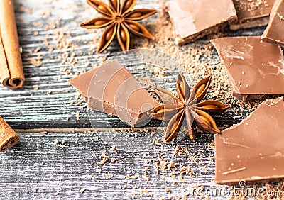 Broken chocolate pieces, cocoa powder, star anise and cinnamon Stock Photo