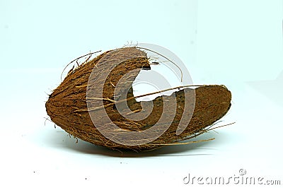 Broken coconut shell on white background. Empty broken ovoid shell composed of cellulose, hemicellulose, and lignin. Stock Photo