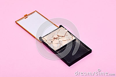 Broken compact make up powder on pink background Stock Photo