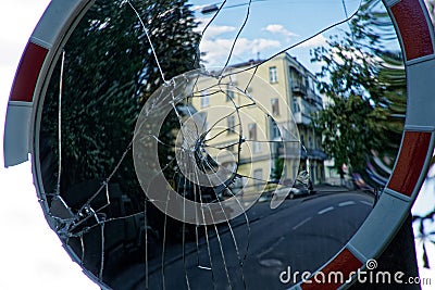 Broken convex mirror with cracked - view from a street mirror to a street Stock Photo