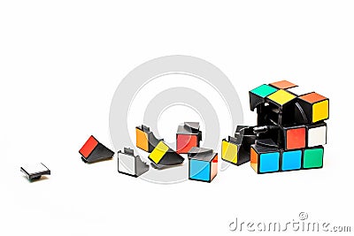 Broken a cube of Rubiks and a part from it. Editorial Stock Photo