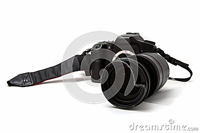 Broken digital SLR camera, dented protective filter on the zoom lens. Will be repaired. Isolated on white background. Side view Stock Photo