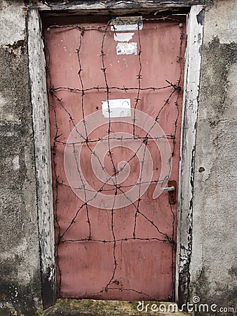 Broken door sealed using wire in a house Stock Photo