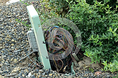 Broken electrical utility box on the street with jumble of exposed wires horizontal Stock Photo