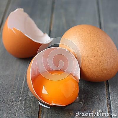 Broken fresh egg on rustic wooden background Stock Photo