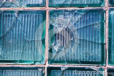 Broken glass for background pattern. Broken window with a bullet hole in the middle Hole in the window. Crash texture Stock Photo