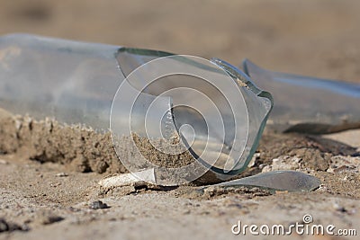 Broken glass bottle in the sand Stock Photo