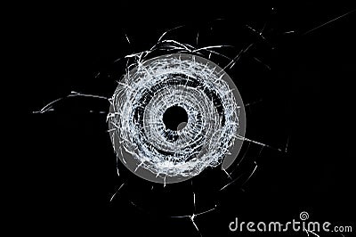 Broken glass single bullet hole in glass isolated on black Stock Photo