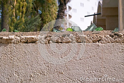 Broken glass on the top of the wall Stock Photo