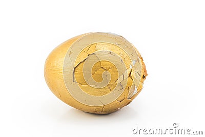 Broken gold egg on a white background Stock Photo