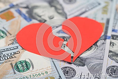 Broken heart on dollar bills Stock Photo