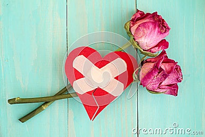 Broken heart and old roses Stock Photo