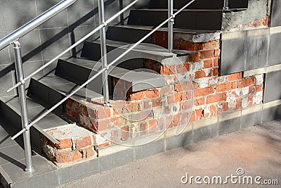 Broken house steps foundation with water leaks outdoor. Damaged stair case need to repair Stock Photo