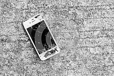 Broken iPhone 4S on asphalt road Editorial Stock Photo