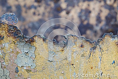 Broken iron surface with old yellow flaky paint on the background of another old iron Stock Photo