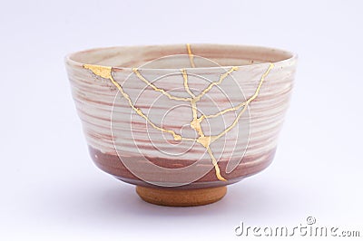 Broken Japanese handmade bowl restored with the antique japanese kintsugi real gold technique Stock Photo