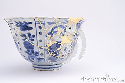 Broken Japanese handmade bowl restored with the antique japanese kintsugi real gold technique Stock Photo