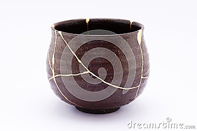 Broken Japanese handmade bowl restored with the antique japanese kintsugi real gold technique Stock Photo