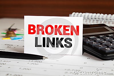 Broken links - text on a notebook with a spring and a gray handle Stock Photo