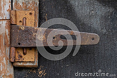 Broken lock, bolt on the door with rust on the old door Stock Photo