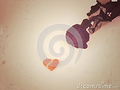 broken love, a black faded rose and a small broken heart in retro style, the authors idea. selective focus Stock Photo