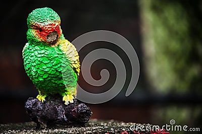 Broken Macaw Bird Statue Stock Photo