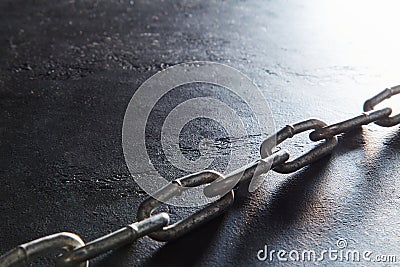 Broken metal chain, copy space. Freedom, liberty concept. Torned up chain on dark textured background, place for text. Stock Photo