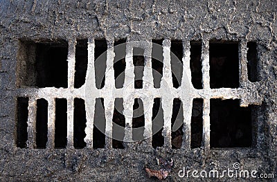 Broken drain grate with mud Stock Photo