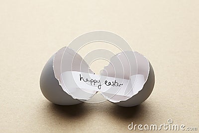 Broken open egg with happy easter message inside Stock Photo