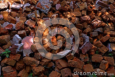 Broken pieces of brown bricks piled at a place. Stock Photo