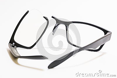 Broken plastic Eyeglasses on colored background Stock Photo