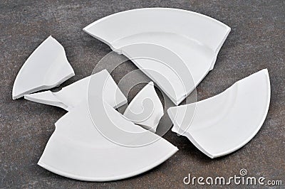 Broken plate close-up on gray background Stock Photo