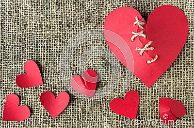 A broken red heart. Sewn thread. The concept of divorce. Stock Photo