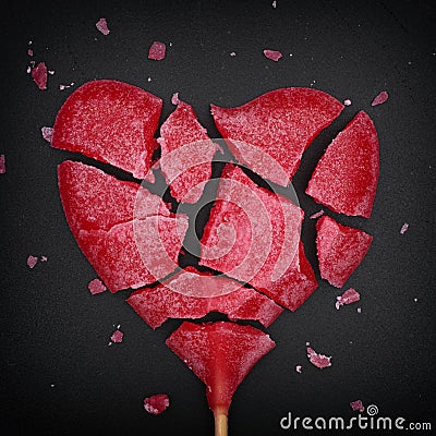 Broken red heart shaped lollipop Stock Photo