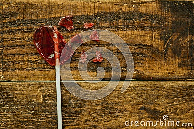 Broken red lollipo with heart shape Stock Photo