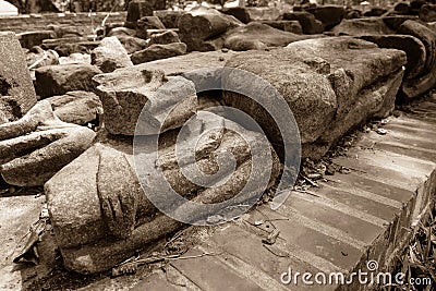 The broken remains of an ancient 20th-century Buddha statue in vintage tone Stock Photo