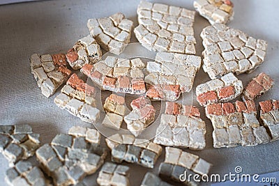 Broken remains of excavated Mosaic floor pieces from a Roman Villa in West Sussex, England Editorial Stock Photo